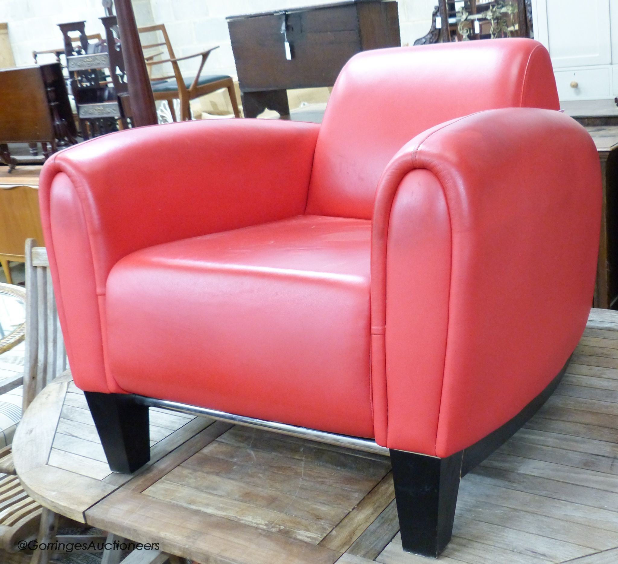 A red leather club armchair, height 70cm, width 87cm, depth 98cm